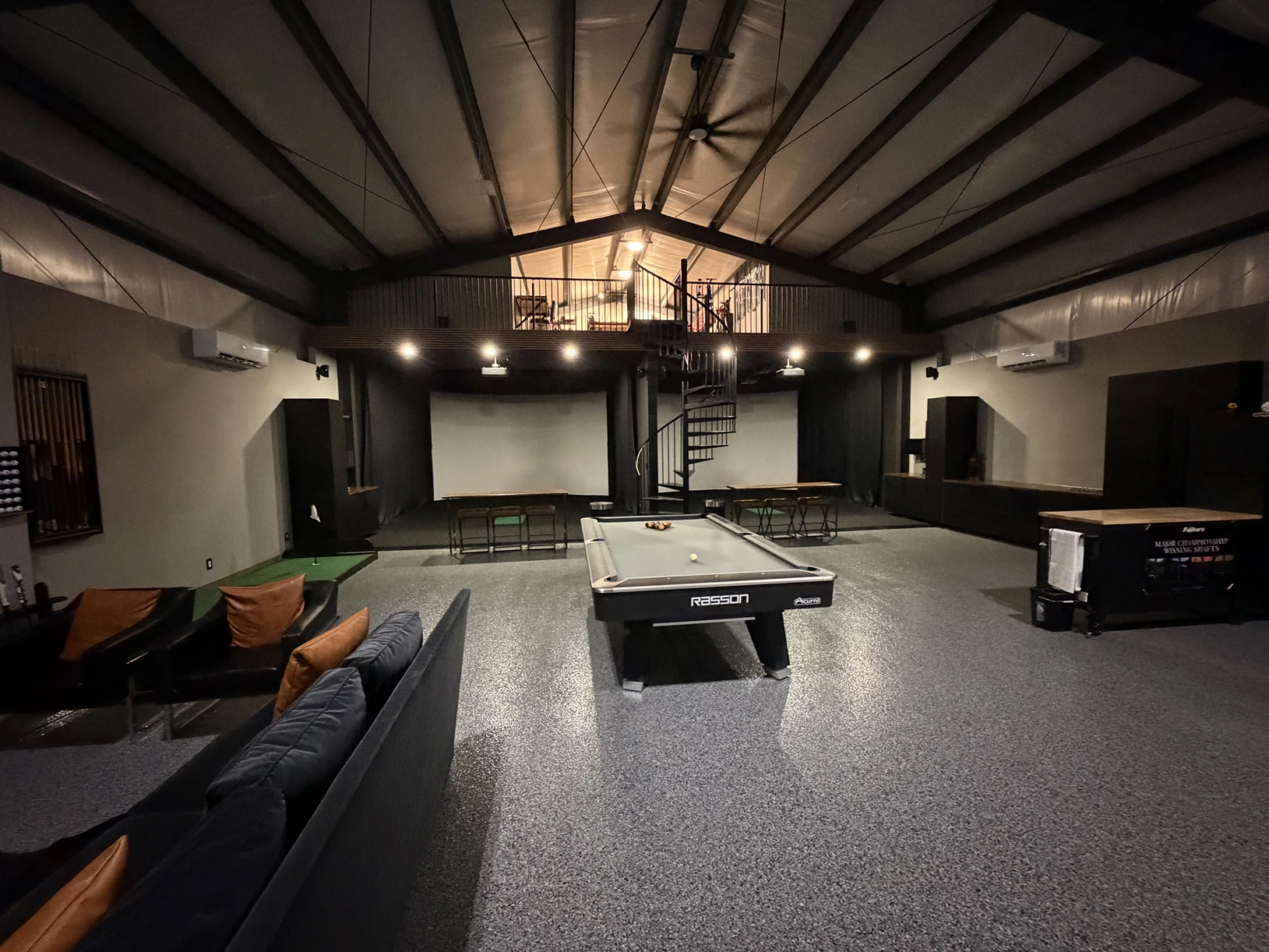 Wide view of the simulator bays, lounge, and billiards table
