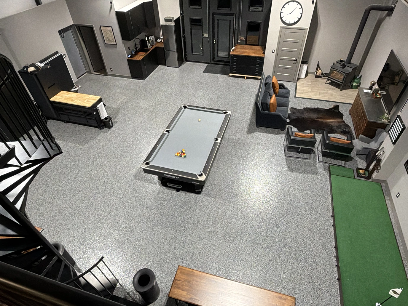 Overhead view of the billiards table, lounge, and putting mat