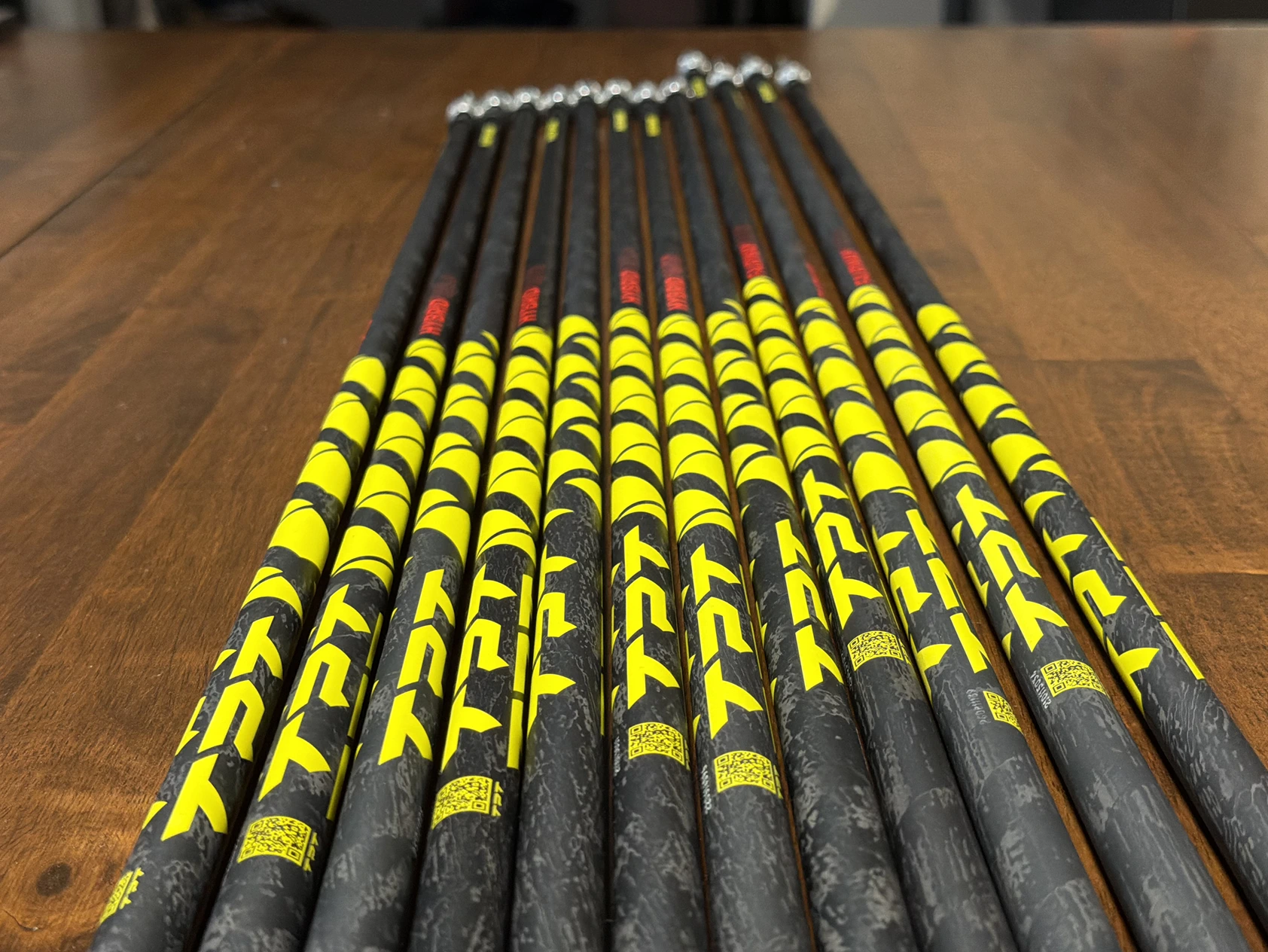 Yellow and black golf shafts laid out on the workshop table