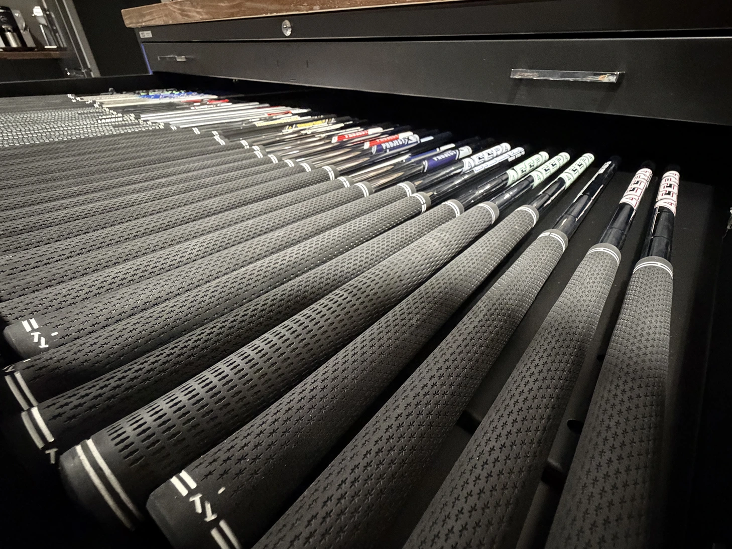 Golf shafts and grips arranged in the fitting workshop